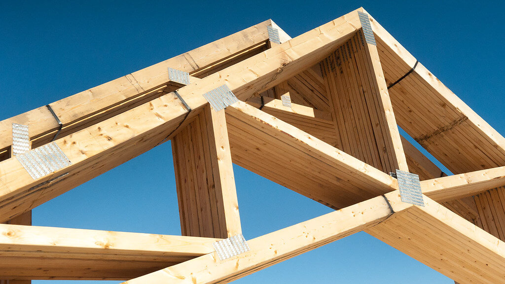 wooden truss at angle against blue sky