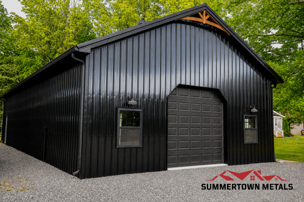 black post frame workshop with garage door and timber frame accent