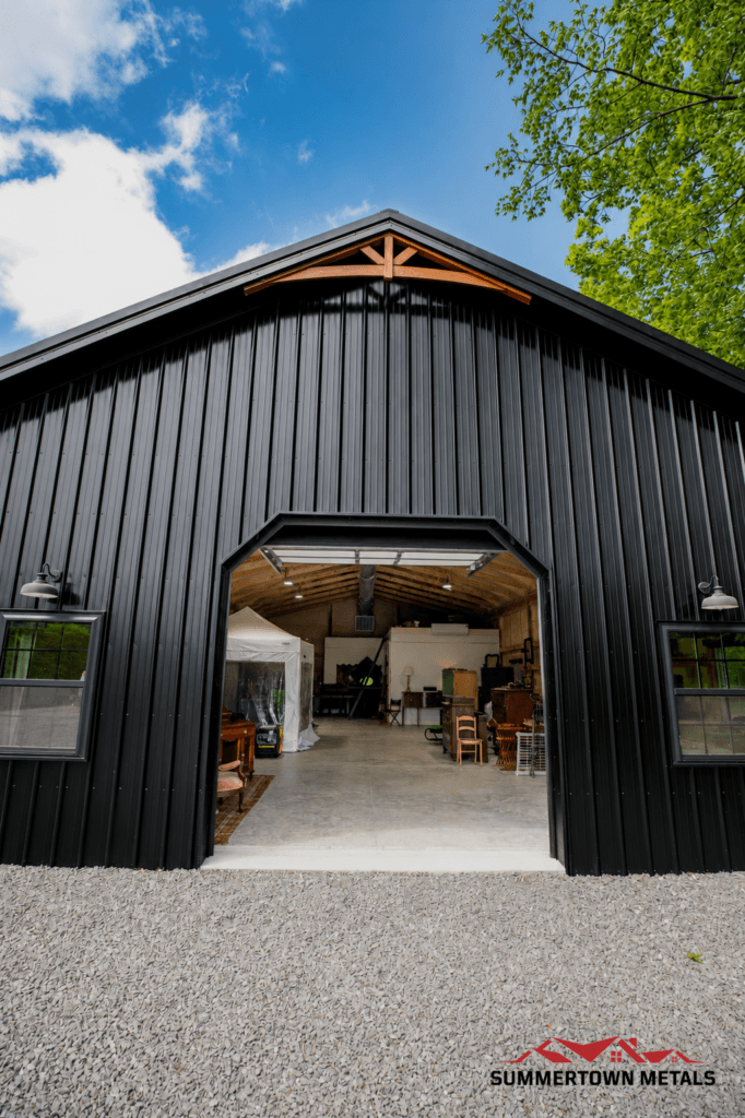 black post frame workshop with open garage door